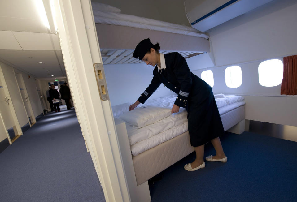 Local Manager Gisela Olsson makes a bed in one of the standard rooms in the Jumbo Hostel at Arlanda Airport, Stockholm January 14, 2009. Jumbo Hostel is a Boeing 747-200 jumbo jet that has been converted into a 25 room hotel and cafe and the cockpit has been converted into a de luxe suite. REUTERS/Fredrik Sandberg/SCANPIX