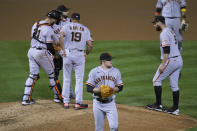 San Francisco Giants starting pitcher Logan Webb walks back to the dugout after being removed by manager Gabe Kapler (19) in the fourth inning of the team's baseball game against the Oakland Athletics on Friday, Sept. 18, 2020, in Oakland, Calif. (AP Photo/Eric Risberg)