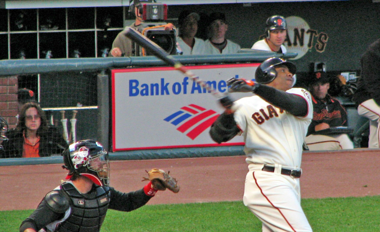 Barry Bonds hits a home run in front of a Bank of America sign.
