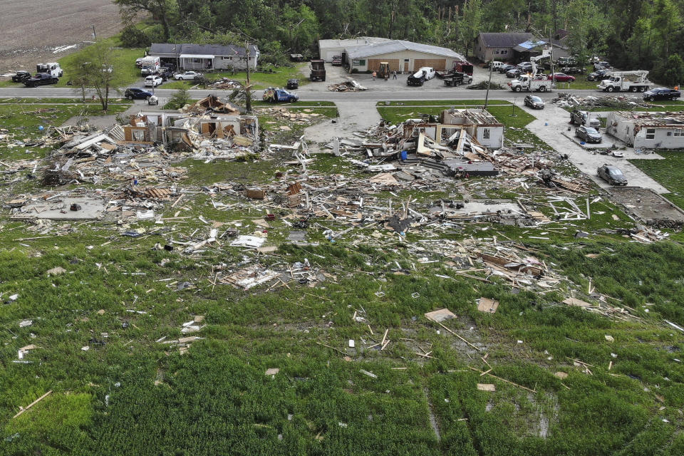 In this aerial image, debris from damaged homes litters the properties on Fairground Road after a tornado storm system passed through the area the previous night, Tuesday, May 28, 2019, in Celina, Ohio. A rapid-fire line of apparent tornadoes tore across Indiana and Ohio overnight, packed so closely together that one crossed the path carved by another. At least half a dozen communities from eastern Indiana through central Ohio suffered damage, according to the National Weather Service. (AP Photo/John Minchillo)