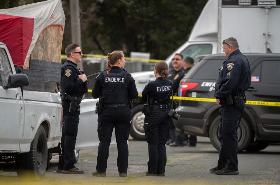 Stockton Police officers and evidence technicians investigate the scene of a homicide of a 24-year-old man on 6th Street and Harrison Street in south Stockton on Jan. 27, 2024.