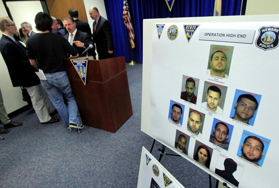 Mug shots of an alleged luxury car theft ring are on display at the end of a news conference, Tuesday, April 17, 2012, in Newark, N.J. Prosecutors say the Newark-based thieves traveled to affluent communities from Bergen to Ocean counties in search of luxury vehicles. They would usually strike during the early morning and most often would grab cars that still had their keys inside. Eleven people have been arrested, most of them from Newark. Among the vehicles recovered were a Porsche, a Ferrari, a Mercedes and two BMWs. (AP Photo/Julio Cortez)