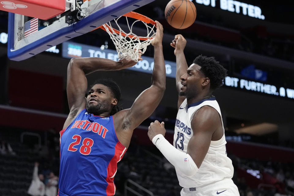 Memphis Grizzlies forward Jaren Jackson Jr. (13) interferes with Detroit Pistons center Isaiah Stewart (28) during the second half of an NBA basketball game, Wednesday, Dec. 6, 2023, in Detroit. (AP Photo/Carlos Osorio)