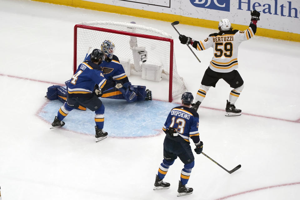 Boston Bruins' Tyler Bertuzzi (59) celebrates after scoring past St. Louis Blues goaltender Jordan Binnington as Blues Nick Leddy (4) and Alexey Toropchenko (13) watch during the second period of an NHL hockey game Sunday, April 2, 2023, in St. Louis. (AP Photo/Jeff Roberson)