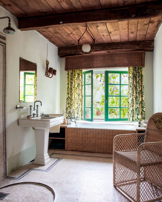 bathroom in country home with a wicker valance, wicker tub surround, and wicker chair