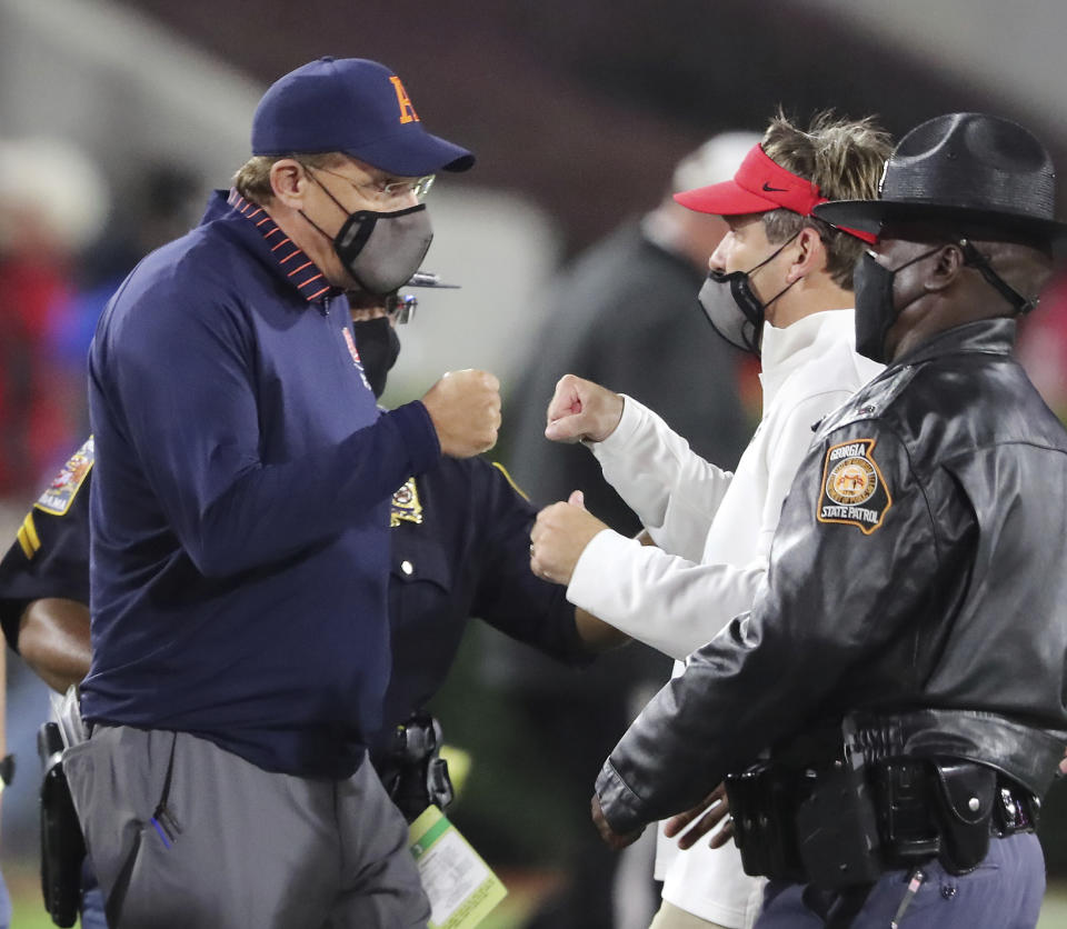 Auburn coach Gus Malzahn, left, gives Georgia coach Kirby Smart a fist bump after Georgia defeated Auburn 27-6 in an NCAA college football game Saturday, Oct. 3, 2020, in Athens, Ga. (Curtis Compton/Atlanta Journal-Constitution via AP)