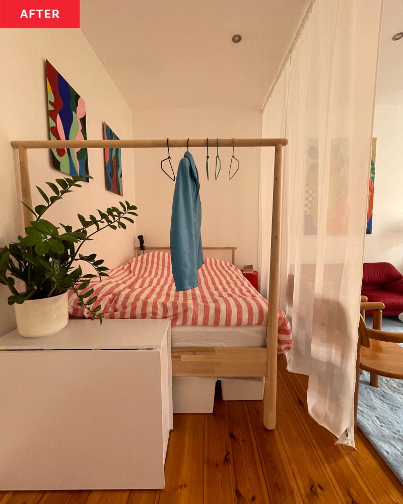 Sheer curtain in studio apartment separating bedroom from living room.