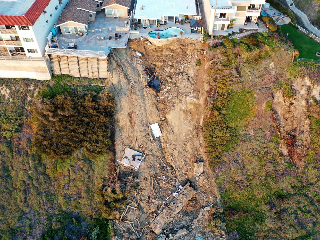 Heavy rains and landslides in California left a swimming pool dangling at the edge of a cliff.