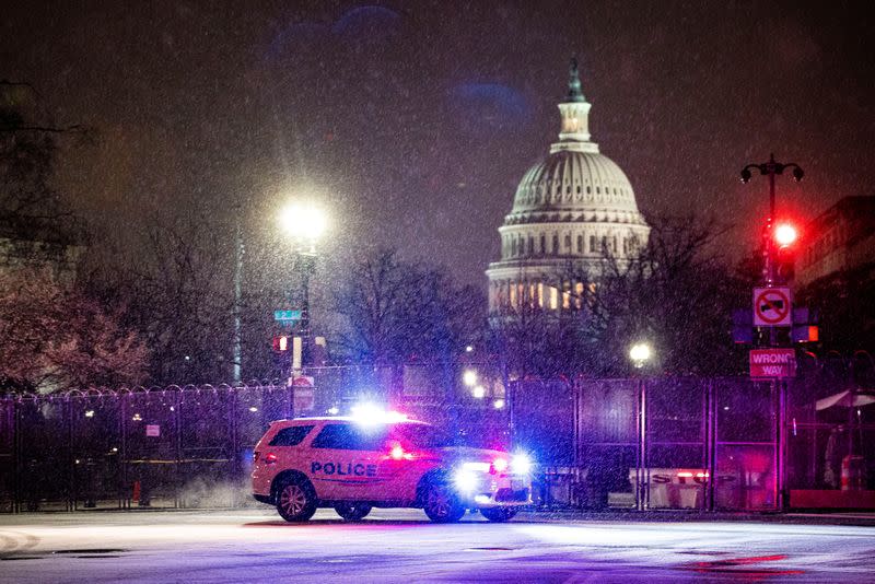 FILE PHOTO: A Metropolitan Police Department car drives through the snow on Capitol Hill