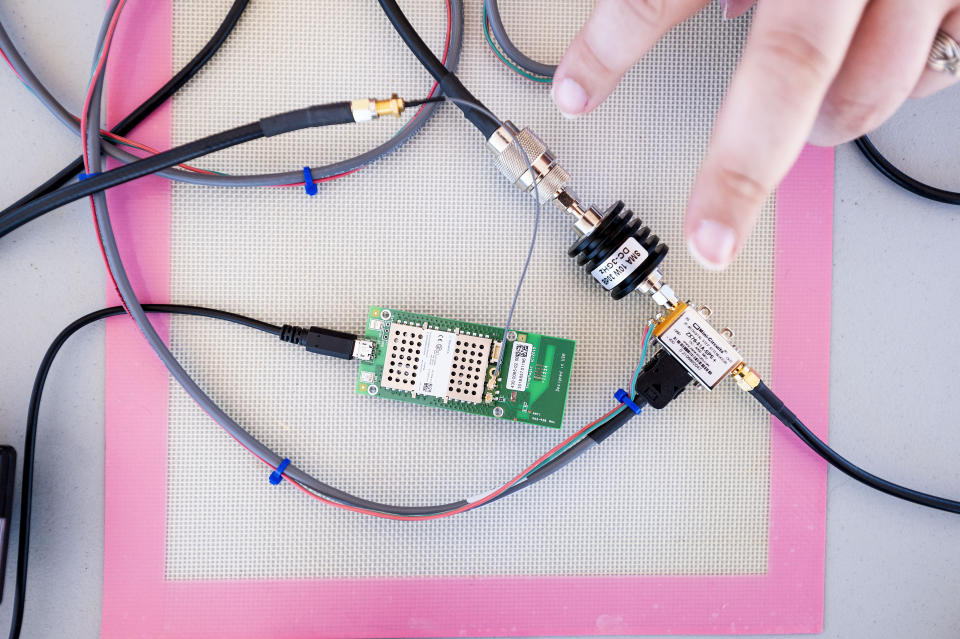 Hacker Kristin Paget describes components used to test radio frequency identification signal range in Hickman, Calif., on Sunday, June 6, 2021. The green board is an RFID reader. Paget says it doesn’t take a Chinese or Russian cyber army to take advantage of vulnerabilities created by putting RFID tags in military guns -- a tinkerer with YouTube access could acquire the skills. (AP Photo/Noah Berger)