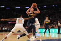 Mar 22, 2019; New York, NY, USA; Denver Nuggets center Nikola Jokic (15) drives past New York Knicks point guard Frank Ntilikina (11) during the first quarter at Madison Square Garden. Mandatory Credit: Brad Penner-USA TODAY Sports