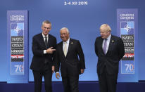NATO Secretary General Jens Stoltenberg, left, and British Prime Minister Boris Johnson, right, welcome Portuguese Prime Minister Antonio Costa at the official arrivals for a NATO leaders meeting at The Grove hotel and resort in Watford, Hertfordshire, England, Wednesday, Dec. 4, 2019. NATO Secretary-General Jens Stoltenberg rejected Wednesday French criticism that the military alliance is suffering from brain death, and insisted that the organization is adapting to modern challenges. (AP Photo/Francisco Seco)