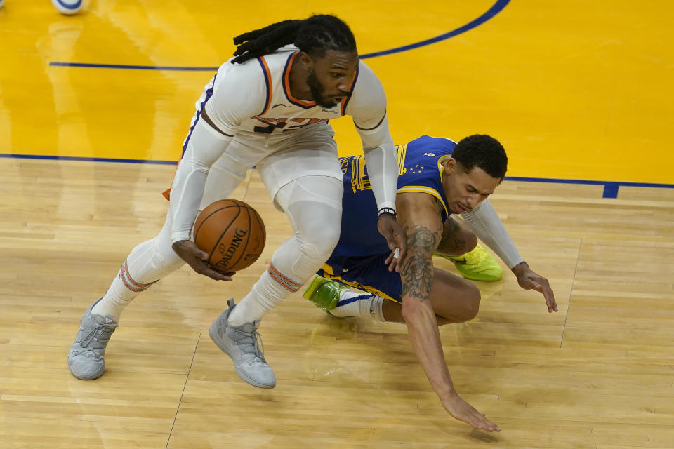 Phoenix Suns forward Jae Crowder, left, grabs the ball in front of Golden State Warriors forward Juan Toscano-Anderson during the first half of an NBA basketball game in San Francisco, Tuesday, May 11, 2021. (AP Photo/Jeff Chiu)
