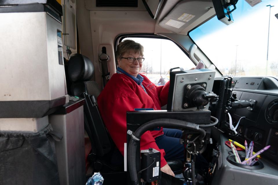 Lana Dillner, a driver for Topeka Transit's MOD fleet, smiles in her cab Tuesday as she waits for riders at Walmart's parking lot at 2630 S.E. California Ave.