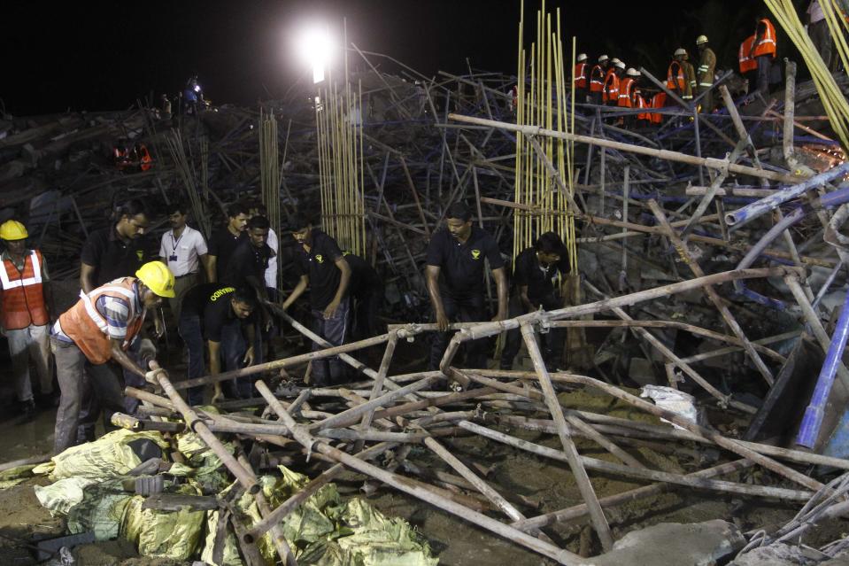 Rescue workers conduct a search operation for survivors at the site of a collapsed 11-storey building that was under construction on the outskirts of Chennai