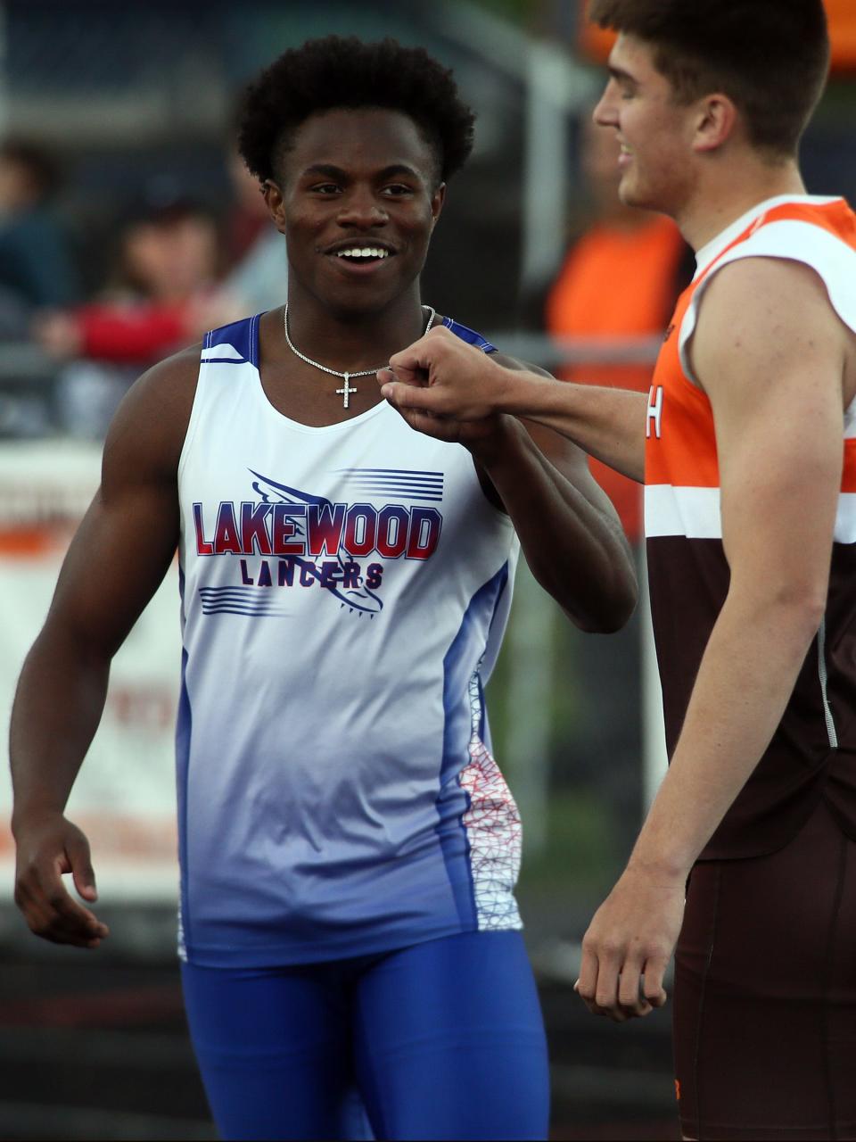 Lakewood's Isaiah Mitchell fist bumps Heath's Brayden Bayles after taking first in the Cardinal Division 100 during the Licking County League championships at Heath on Friday, May 10, 2024.