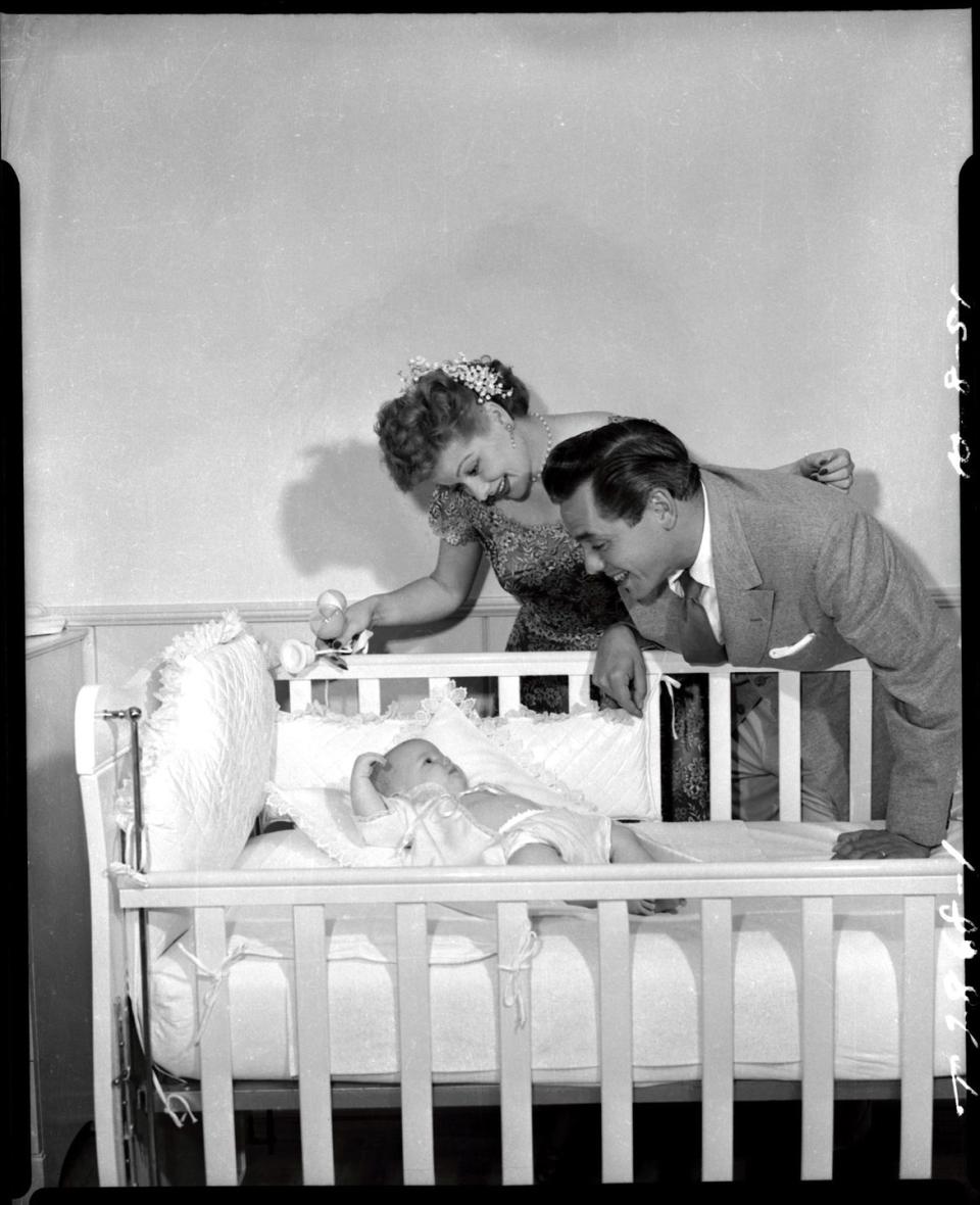 1951: Gazing at her newborn daughter with with Desi
