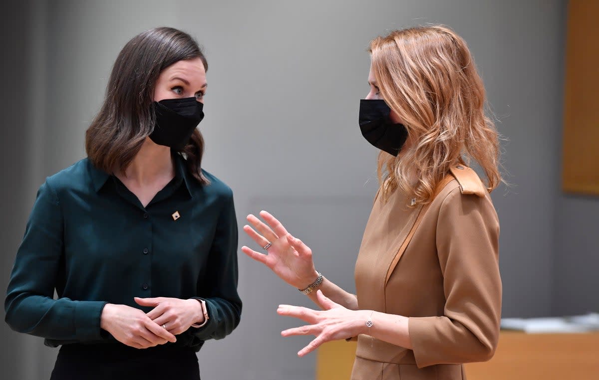 Finland’s prime minister Sanna Marin (L) speaks with her Estonian counterpart Kaja Kallas in Brussels on 15 December, 2021. (AP)