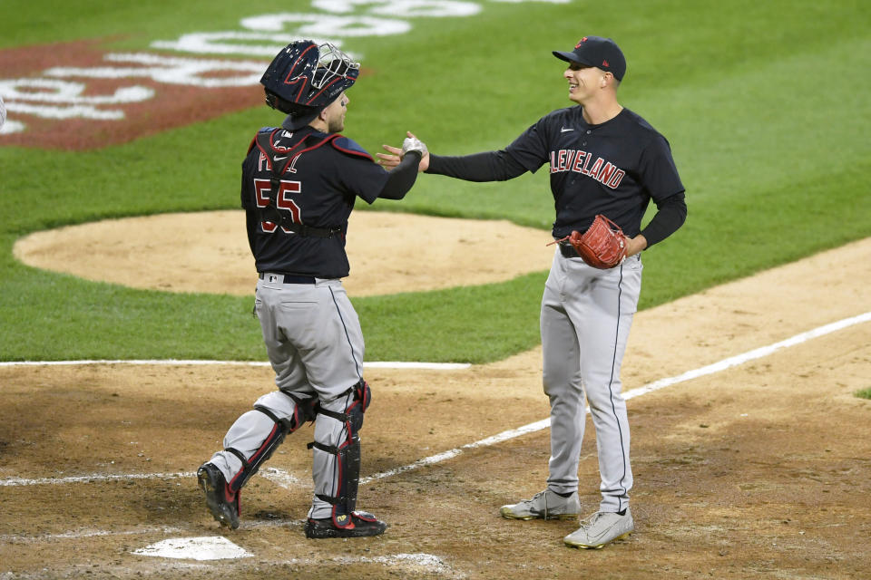 Cleveland Indians closing pitcher James Karinchak right, celebrates with catcher Roberto Perez left, after defeating the Chicago White Sox 2-0 in ten innings of a baseball game Tuesday, April 13, 2021, in Chicago. (AP Photo/Paul Beaty)