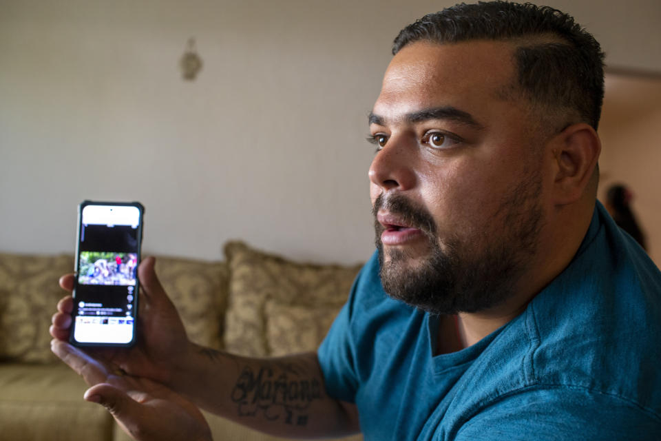 Venezuelan asylum-seeker Luis Lopez shows a picture of his family crossing Panama's Darien Gap, during an interview with The Associated Press in El Paso, Texas, Friday, May 12, 2023. (AP Photo/Andres Leighton)