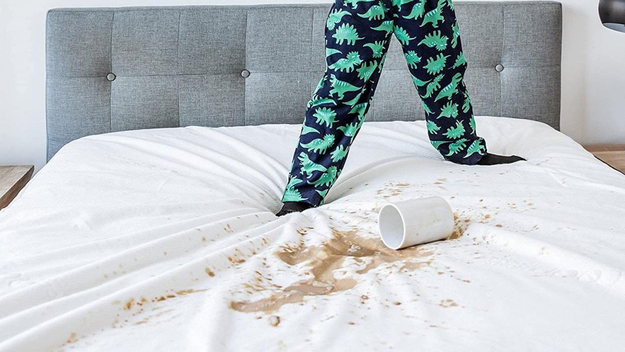  Child spilling drink on Co-Op Goods mattress protector. 