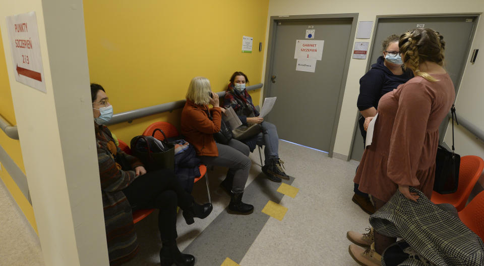 Polish teachers wait to be administered with their first shot of the AstraZeneca vaccine against the coronavirus in Krakow, Poland, Friday Feb. 12, 2021. As Poland began vaccinating teachers on Friday, many say they are unhappy that they are getting AstraZeneca vaccines against the coronavirus, rather than the Pfizer shots earmarked for health care workers and the elderly. Nearly a year into the pandemic, many Europeans and others globally are desperate to get vaccinated and return to normal life. But many don't want just any vaccine. (AP Photo/Czarek Sokolowski)