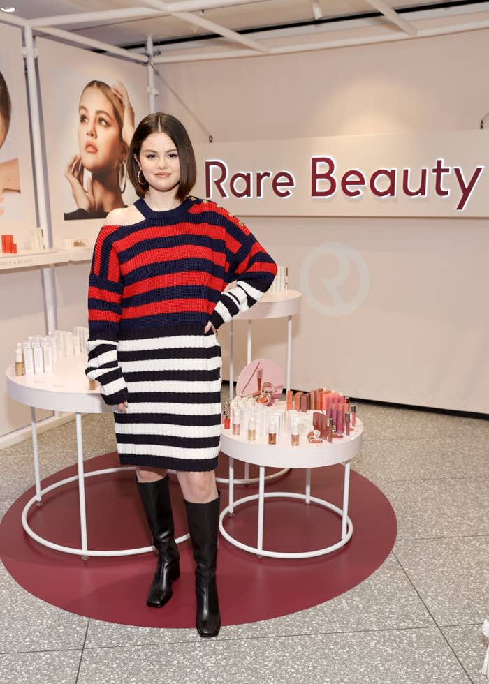 Selena Gomez standing with Rare Beauty merchandise at Sephora in Times Square