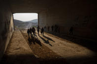 Bedouin students walks towards their school at the West Bank hamlet of Khan al-Ahmar, Tuesday, Jan. 24, 2023. The long-running dispute over the West Bank Bedouin community of Khan al-Ahmar, which lost its last legal protection against demolition four years ago, resurfaced this week as a focus of the frozen Israeli-Palestinian conflict. Israel's new far-right ministers vow to evacuate the village as part of a wider project to expand Israeli presence in the 60% of the West Bank over which the military has full control. Palestinians seek that land for a future state. (AP Photo/Oded Balilty)