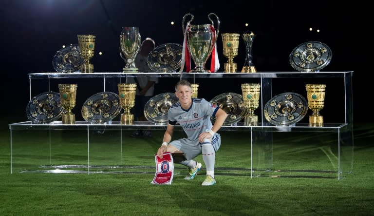 Former Germany captain and Chicago Fire midfielder Bastian Schweinsteiger poses in front of some of the trophies he won during his 17-year career with Bayern Munich, who he joined as a 13-year-old in 2002 before leaving in 2015 for Manchester United