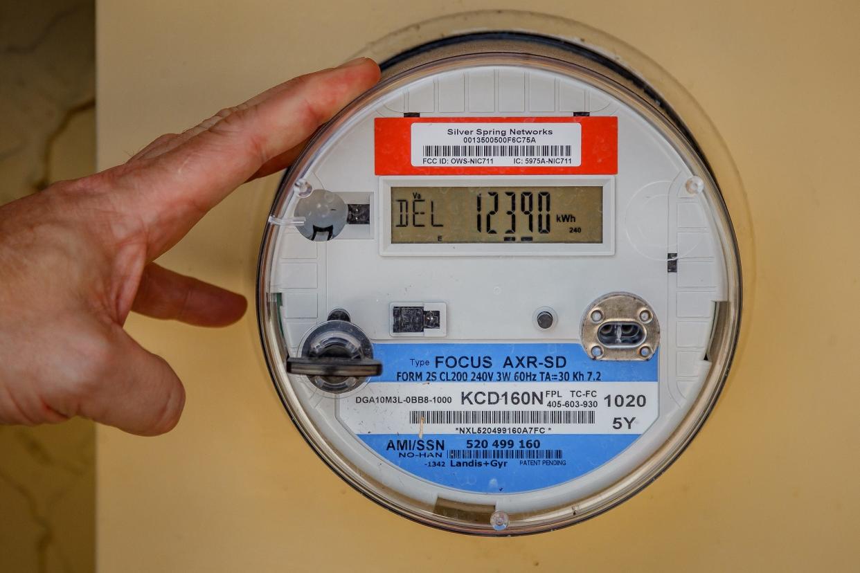 Andrew Broadbent shows his electricity meter at his home in unincorporated Palm Beach County, Fla., on Friday, March 4, 2022. State legislation may impact solar installations and the small industry in the Sunshine State. Rule changes to net metering may be signed into law in the coming weeks. Broadbent installed solar panels at his home last year.