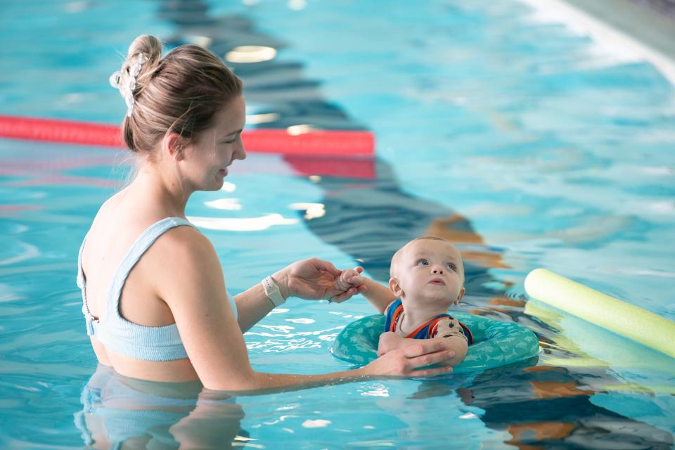 Katie Goodwin and her 9-month-old son Brooks move around the pool at the Pueblo Regional Center on Friday, Jan. 13, 2023. Goodwin serves as a care provider for Remington Harmes who was at the pool during a new sensory swim program for people with disabilities.