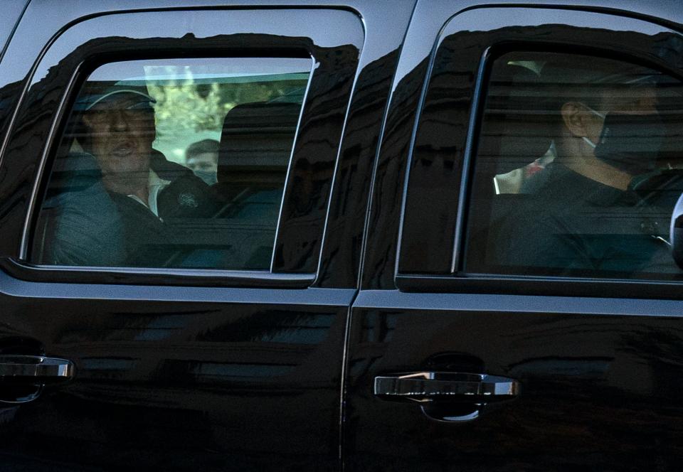 US President Donald Trump watches from the motorcade as he returns to the White House in Washington, DC, after playing golf on November 7, 2020. - Joyous celebrations erupted in Washington on Saturday after Joe Biden was declared winner of the US presidency, as several people poured into the streets of the US capital -- some of them chanting, cheering and singing in front of the White House. (Photo by ALEX EDELMAN / AFP) (Photo by ALEX EDELMAN/AFP via Getty Images)