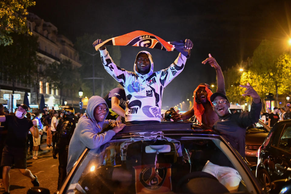 PARIS, FRANCE - AUGUST 19: PSG fans gathered in Champs Elysee to celebrate the winning in the UEFA Champions League semi-finals in Paris, France on August 19, 2020. Police take security measures around the site. France's Paris Saint-Germain has reached the UEFA Champions League final for the first time after beating German side RB Leipzig 3-0 Tuesday. (Photo by Julien Mattia/Anadolu Agency via Getty Images)