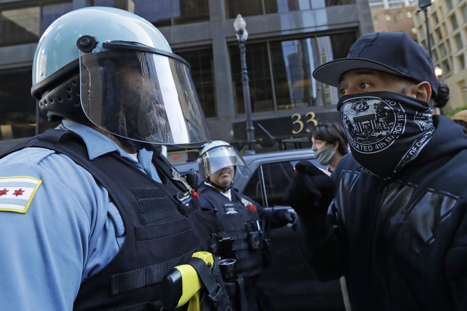 Protesters confront police officers during a protest over the death of George Floyd in Chicago, Saturday, May 30, 2020. Floyd died after being taken into custody and restrained by Minneapolis police on Memorial Day in Minnesota. (AP Photo/Nam Y. Huh)