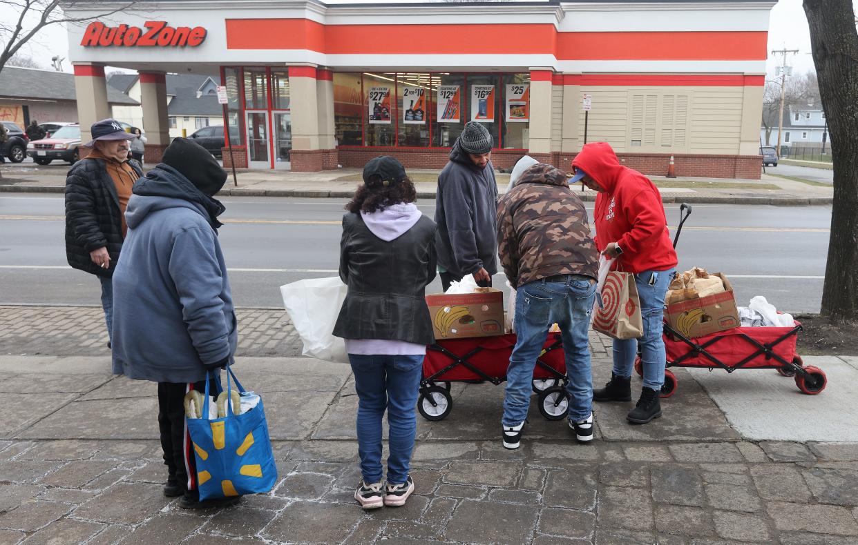 Volunteers and members of MC Collaborative walking through the North Clinton Ave. community to hand out food and personal supplies to anyone in need.