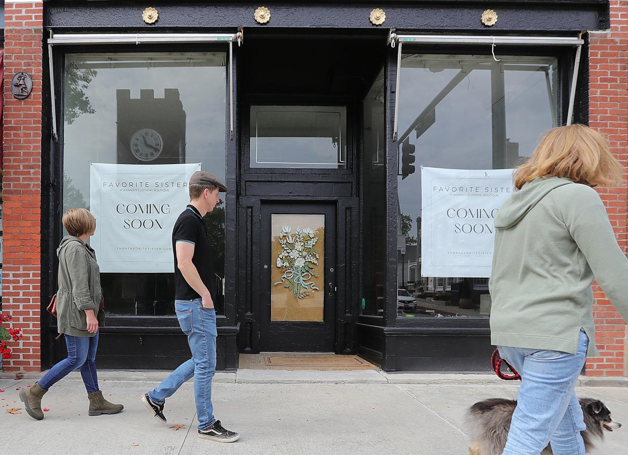 Main Street shoppers pass by the Favorite Sister clothier, which is opening in November in The Grey Colt's former space in downtown Hudson.