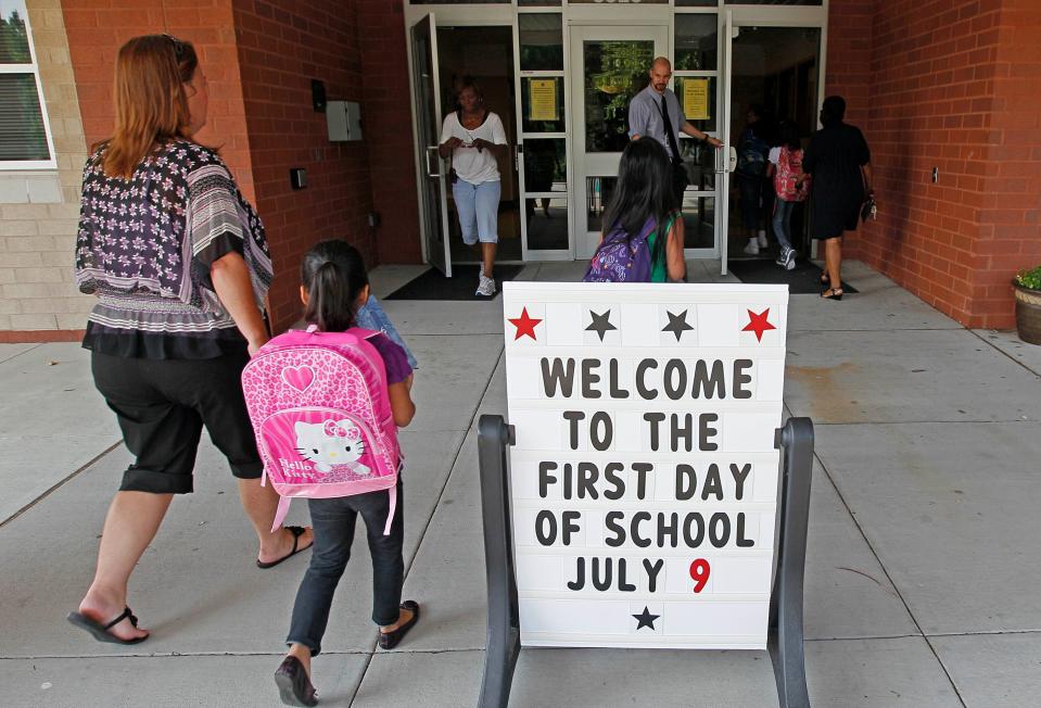 In this file photo, students return for their first day of classes at Barwell Road Elementary School in Raleigh, N.C., Monday, July 9, 2012.