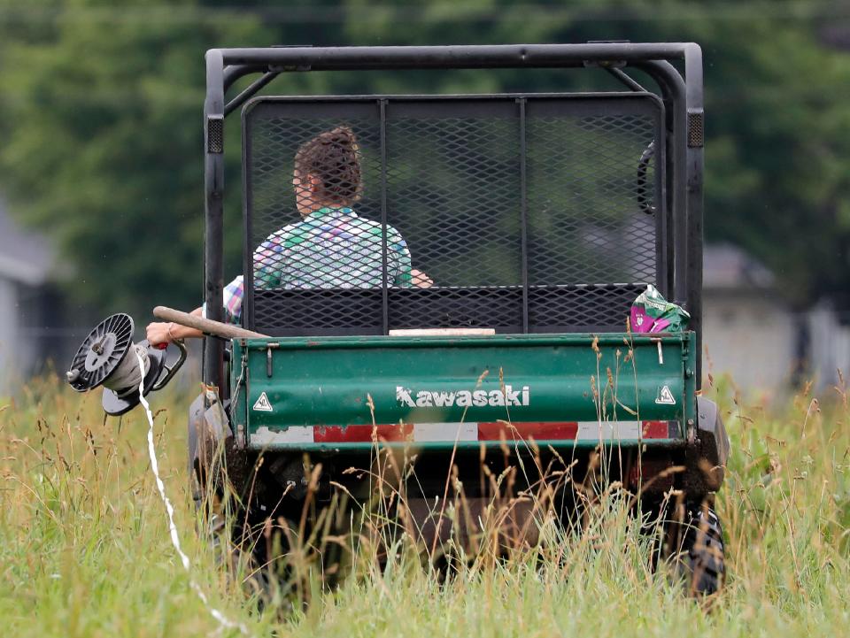 Rachel Bouressa spools out line while deviding a pasture in to two smaller pastures on the Bouressa Family Farm last summer in the Township of Royalton.