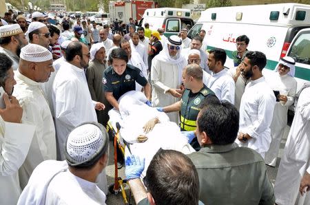 Paramedics rush a victim of a suicide bomb attack at Imam al-Sadeq Mosque, to the Amiri hospital in Al Sharq, Kuwait City, June 26, 2015. REUTERS/Stringer