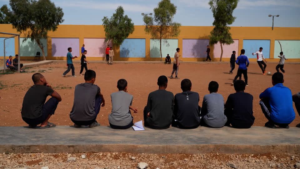 Boys play soccer in the courtyard of the Orkesh “rehabilitation” center, where the sons of ISIS supporters are detained. - CNN