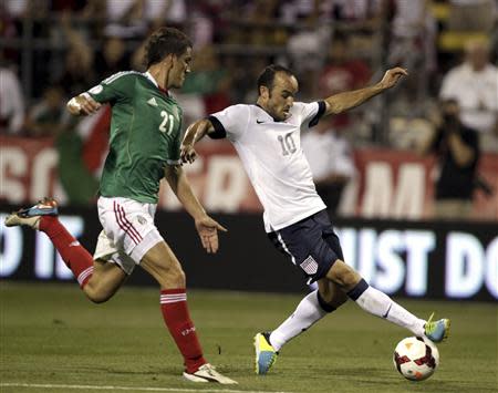 United States' Landon Donovan (10) fights for the ball with Mexico's Hiram Mier (21) during the first half of their 2014 World Cup qualifying soccer match in Columbus, Ohio September 10, 2013. REUTERS/Matt Sullivan