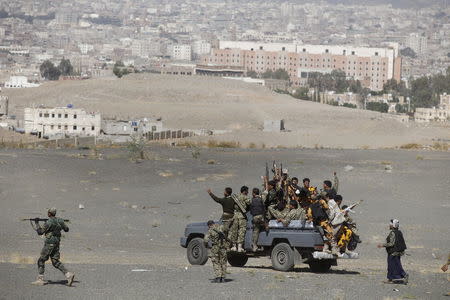 Newly recruited Houthi militants ride on the back of a patrol truck as they leave the site of a gathering held by tribesmen loyal to the Houthi movement, in Yemen's capital Sanaa December 14, 2015. REUTERS/Khaled Abdullah