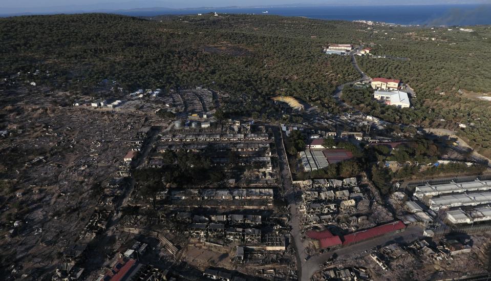 The burned Moria refugee camp is seen from above on the northeastern island of Lesbos, Greece, Thursday, Sept. 10, 2020. Little remained of Greece's notoriously overcrowded Moria refugee camp Thursday after a second fire overnight destroyed nearly everything that had been spared in the original blaze, leaving thousands more people in need of emergency housing. (AP Photo/Panagiotis Balaskas)