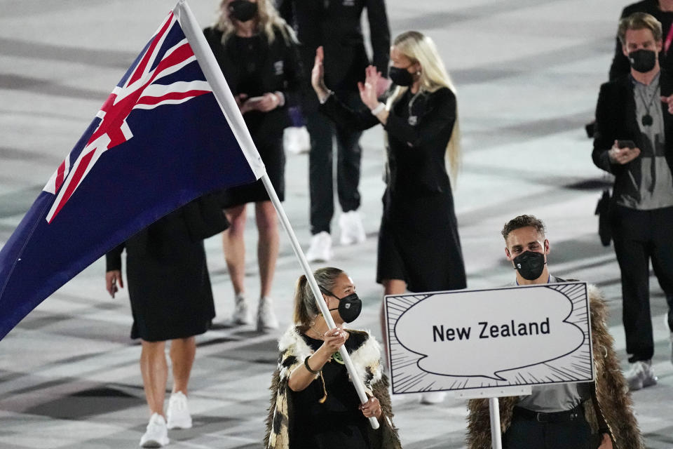 Sarah Hirini and David Nyika, of New Zealand, carry their country's flag during the opening ceremony in the Olympic Stadium at the 2020 Summer Olympics, Friday, July 23, 2021, in Tokyo, Japan. (AP Photo/David J. Phillip)