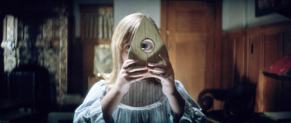 Lulu Wilson looks through a Ouija piece
