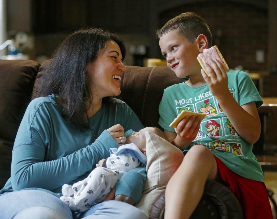 Domenik Detwiler shares a laugh with mom Carlla while she holds David. (Jeff Lange)