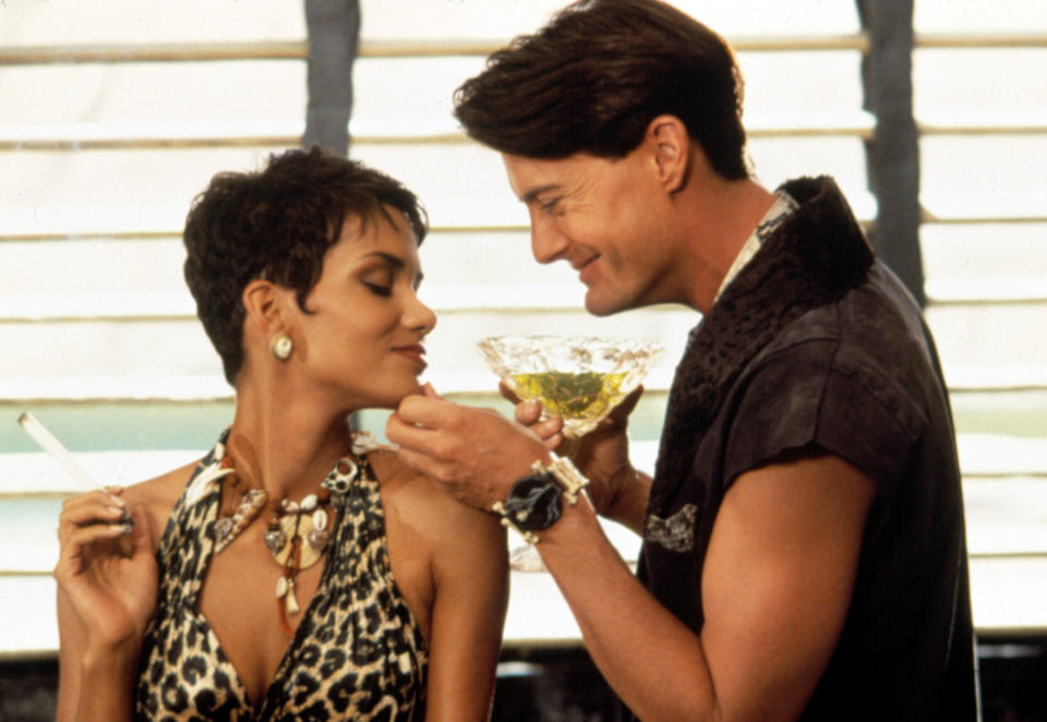 Halle Berry and Kyle MacLachlan as the appropriately-named Sharon Stone and Cliff Vandercave in 1994's The Flintstones. (Alamy)