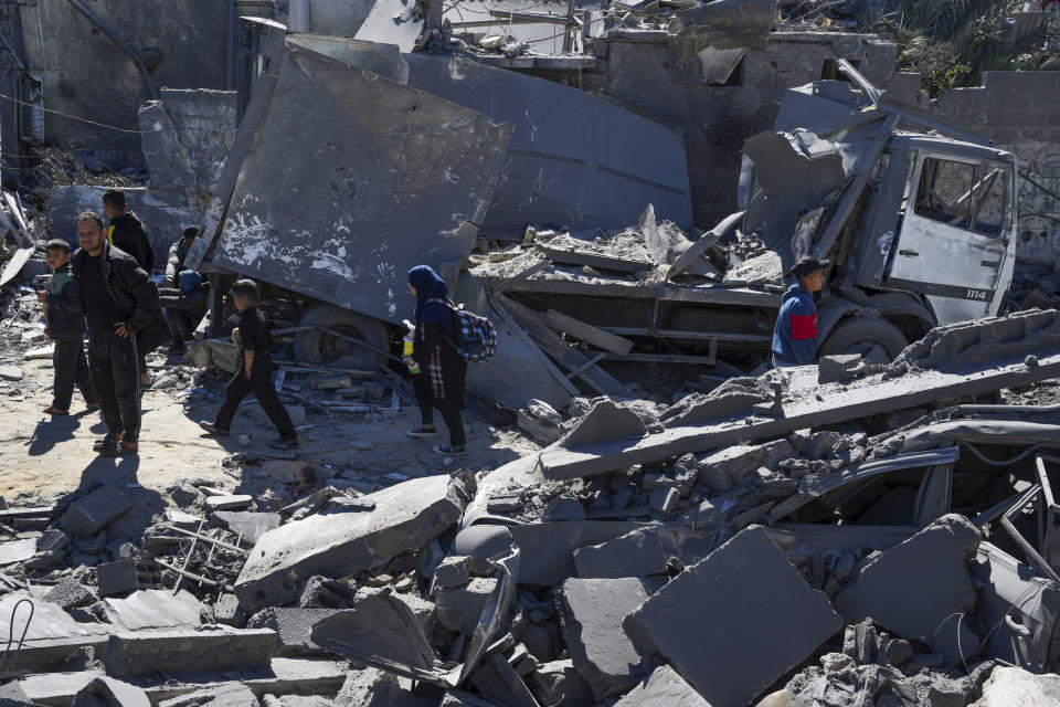 Palestinians inspect the rubble of destroyed buildings after an Israeli airstrike in Nusseirat refugee camp, central Gaza Strip, on Thursday, Feb. 29, 2024. (AP Photo/Adel Hana)