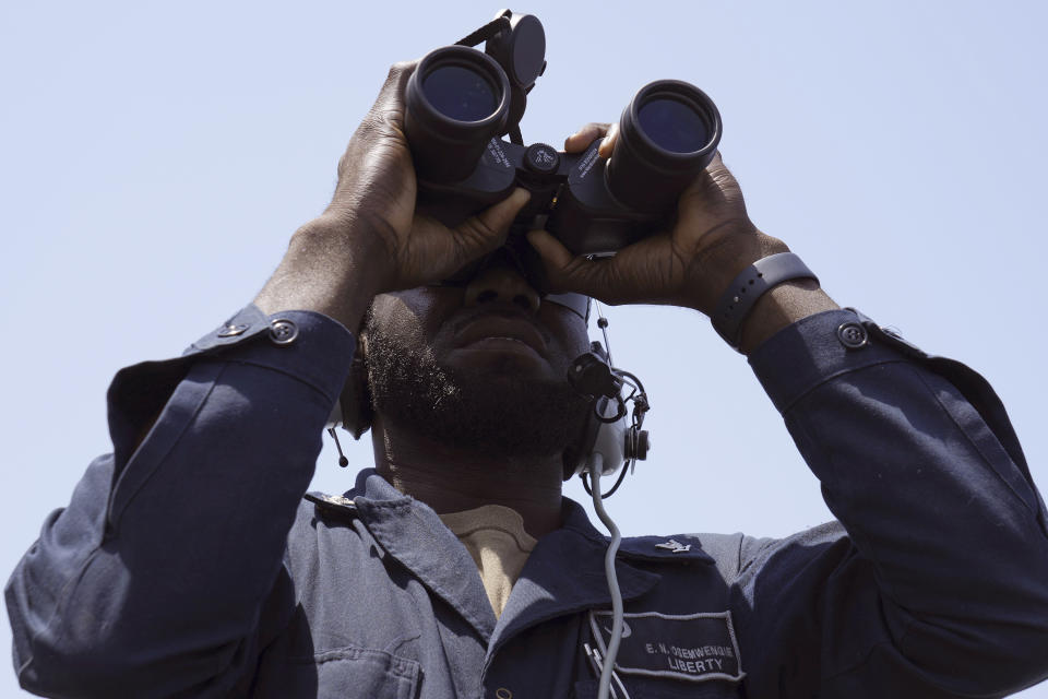 U.S. Navy Boatswain's Mate 3rd Class Elvis Osemwengie stands watch aboard the USS Paul Hamilton in the Strait of Hormuz Friday, May 19, 2023. The Mideast-based chiefs of the U.S., British and French navies transited the Strait of Hormuz on Friday aboard an American warship, a sign of their unified approach to keep the crucial waterway open after Iran seized two oil tankers. (AP Photo/Jon Gambrell)