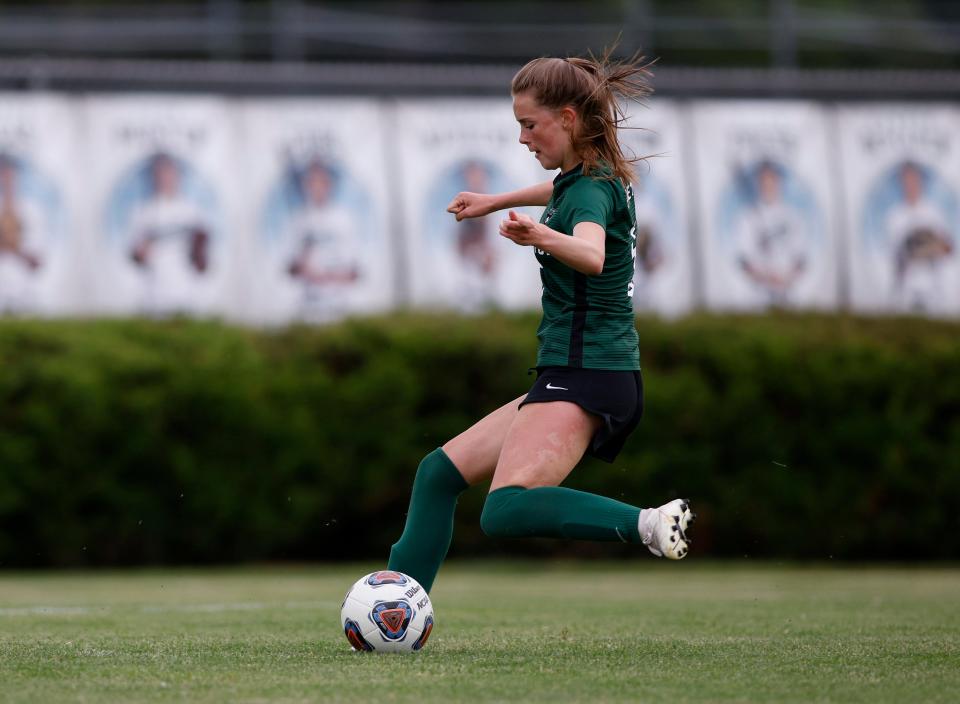 Williamston's Ella Kleiver kicks the first goal of the game against Flint Powers Catholic, Saturday, June 11, 2022, in Williamston. The goal turned out to be the game-winner as Williamston got a 4-0 shutout.